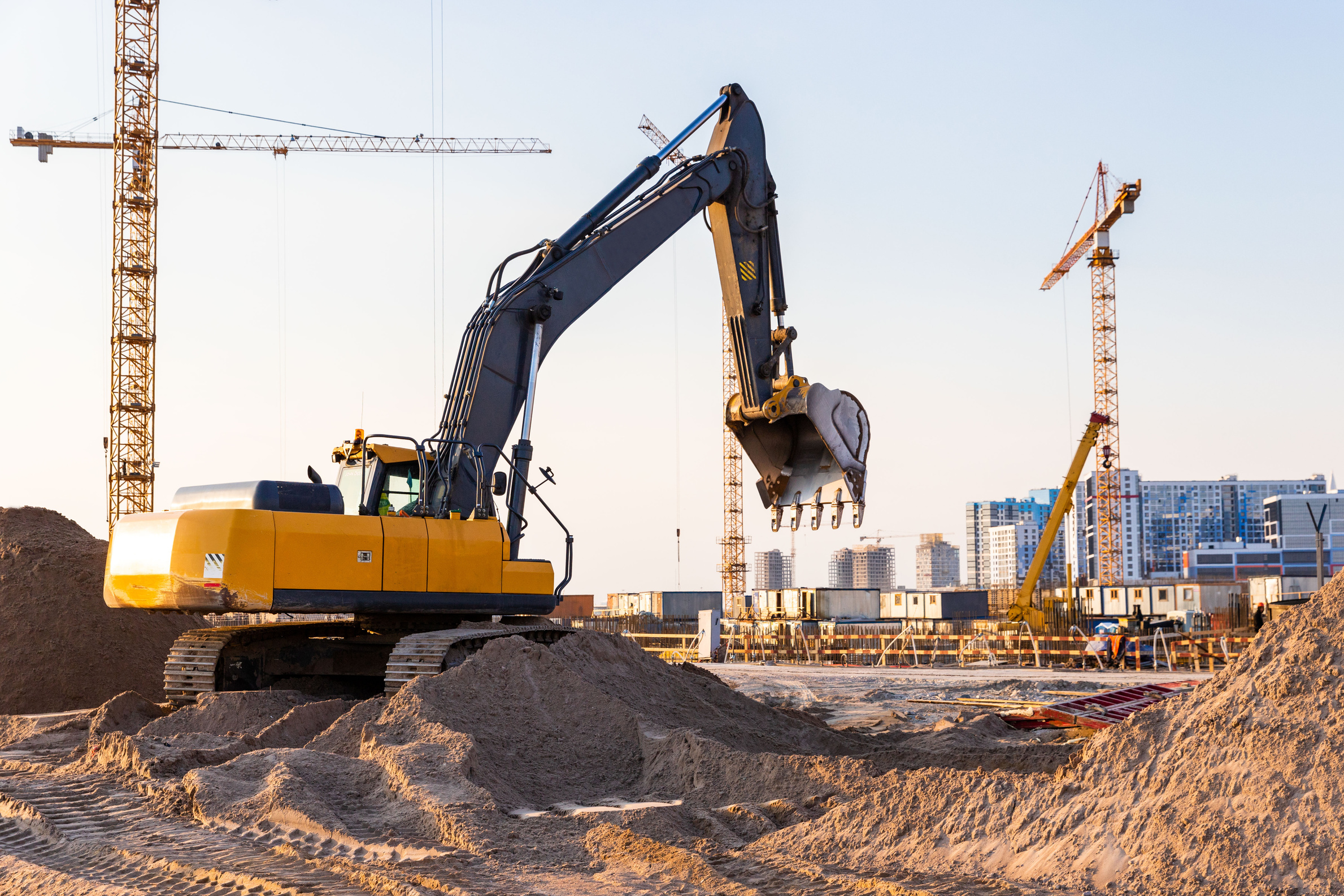 Tower Cranes and Excavator at Construction Site